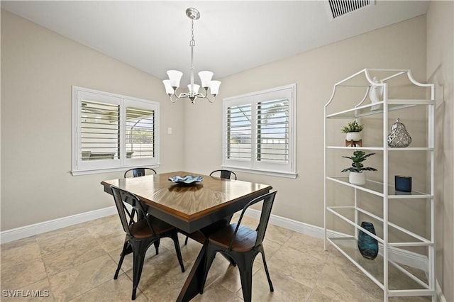 dining room with vaulted ceiling and a chandelier