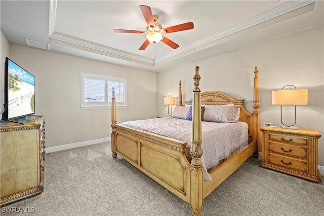 bedroom with crown molding, ceiling fan, a raised ceiling, and light carpet