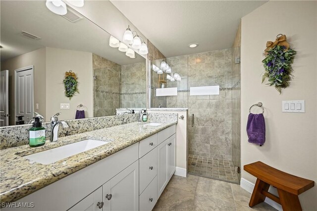 bathroom with vanity and a shower with shower door