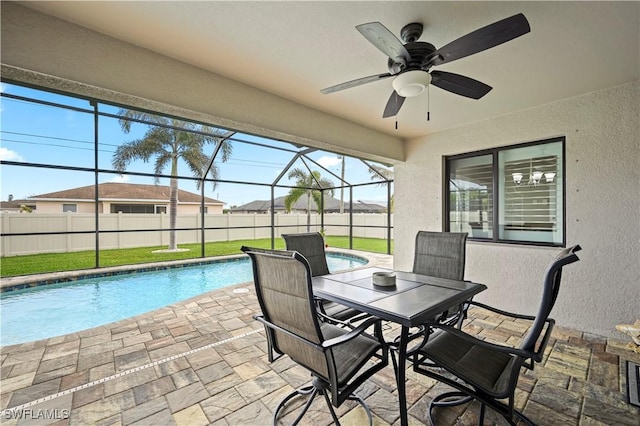 exterior space with ceiling fan, a fenced in pool, and glass enclosure