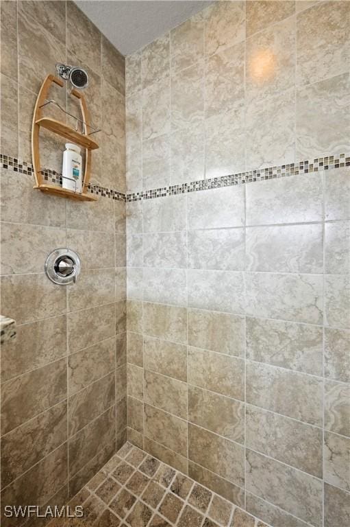 bathroom with tiled shower