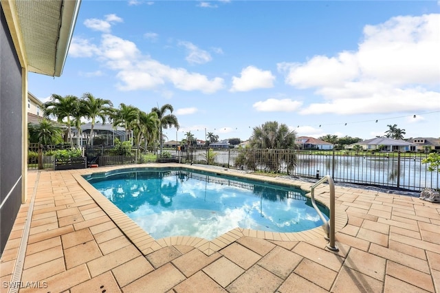 view of swimming pool featuring a patio and a water view