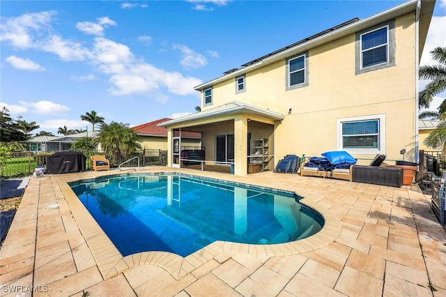 view of pool featuring a patio area and a sunroom