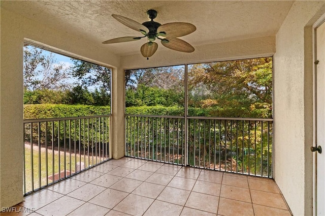 unfurnished sunroom with ceiling fan