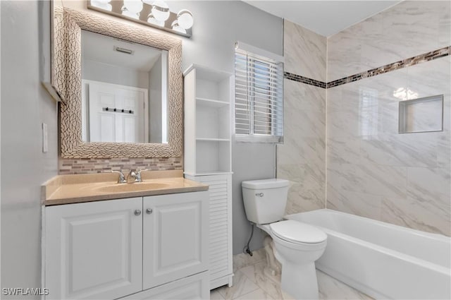 full bathroom featuring tasteful backsplash, tiled shower / bath, vanity, and toilet