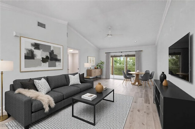 living room featuring lofted ceiling, crown molding, ceiling fan, and light wood-type flooring