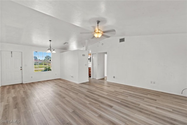 unfurnished living room featuring vaulted ceiling, ceiling fan with notable chandelier, and light hardwood / wood-style flooring