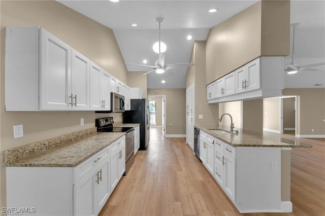 kitchen featuring kitchen peninsula, ceiling fan, stainless steel appliances, light stone countertops, and white cabinets