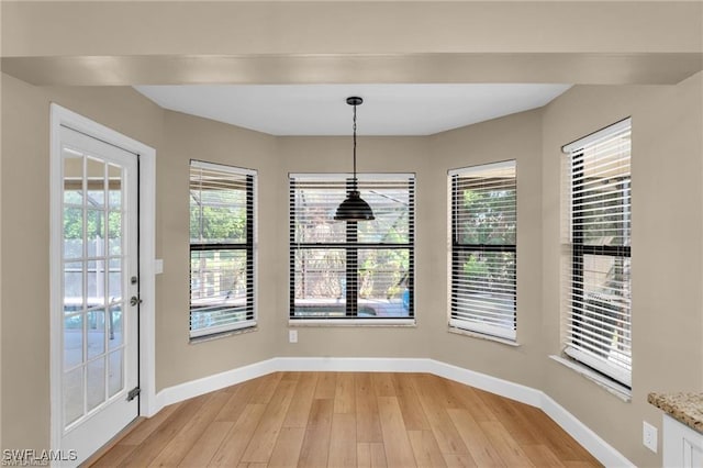 unfurnished dining area with light wood-type flooring