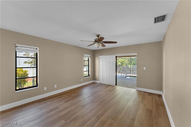 empty room featuring ceiling fan and light hardwood / wood-style flooring