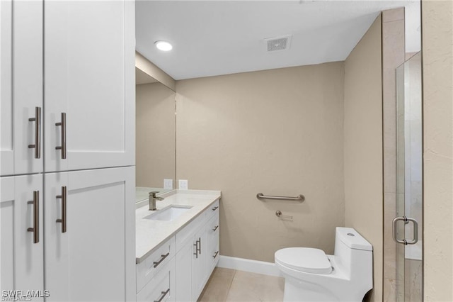 bathroom with vanity, tile patterned floors, toilet, and walk in shower