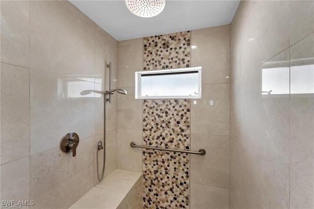 bathroom with tiled shower