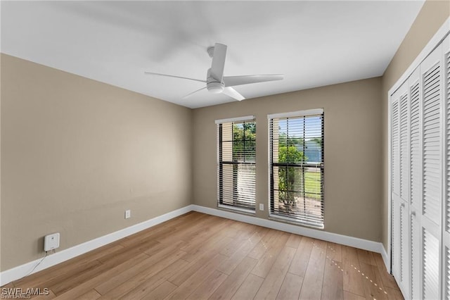 unfurnished bedroom with ceiling fan, light hardwood / wood-style floors, and a closet