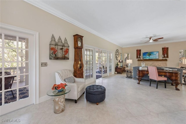 sitting room with ornamental molding, light tile patterned flooring, and ceiling fan