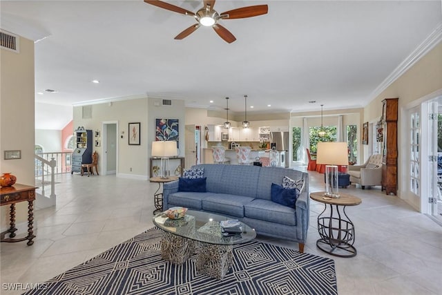 tiled living room with crown molding and ceiling fan