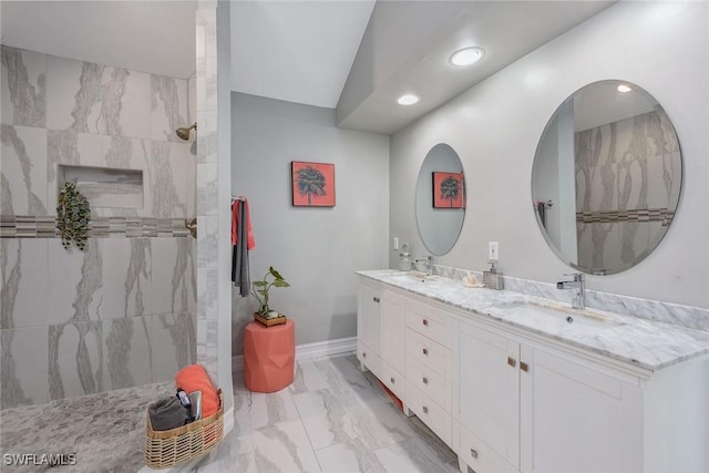 bathroom with vanity and a tile shower