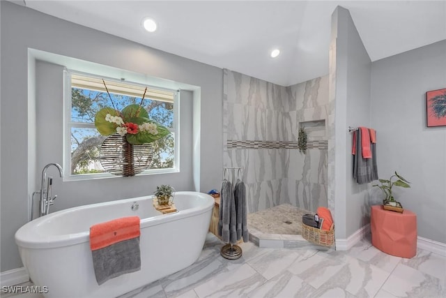 bathroom with lofted ceiling and plus walk in shower