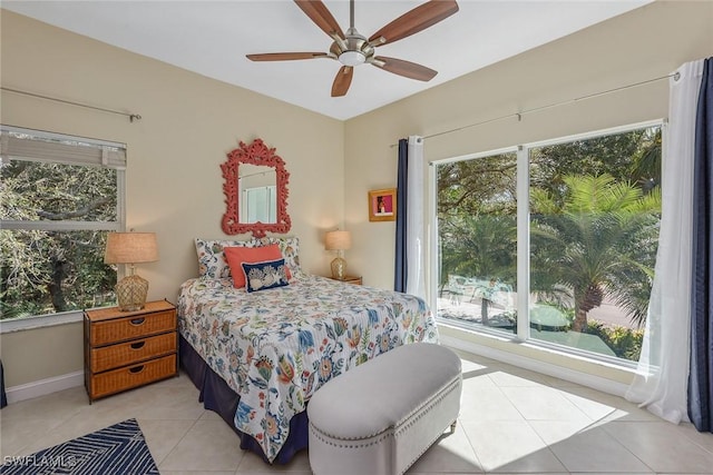 tiled bedroom featuring ceiling fan