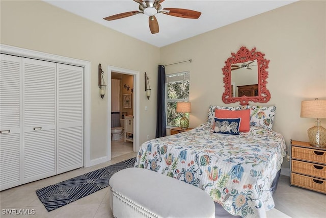 bedroom with ensuite bathroom, light tile patterned floors, ceiling fan, and a closet