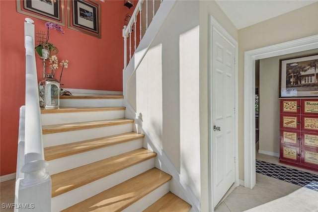 staircase with tile patterned floors