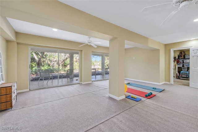 interior space with ceiling fan and light colored carpet