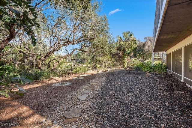 view of yard featuring a sunroom