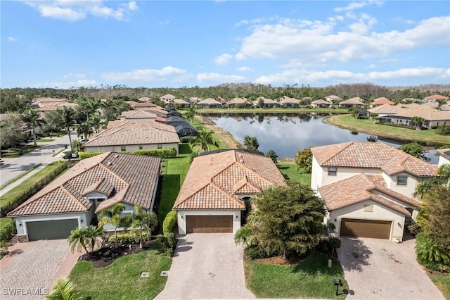 drone / aerial view featuring a water view and a residential view