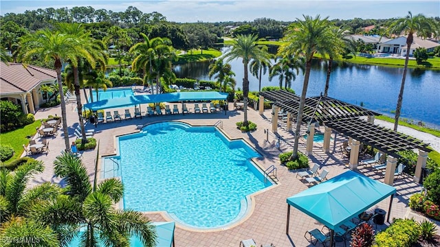 view of swimming pool featuring a water view, a pergola, and a patio area