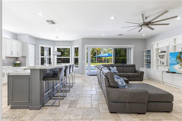 living room with sink and ceiling fan