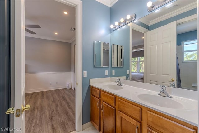 bathroom featuring vanity, hardwood / wood-style floors, plenty of natural light, and ornamental molding