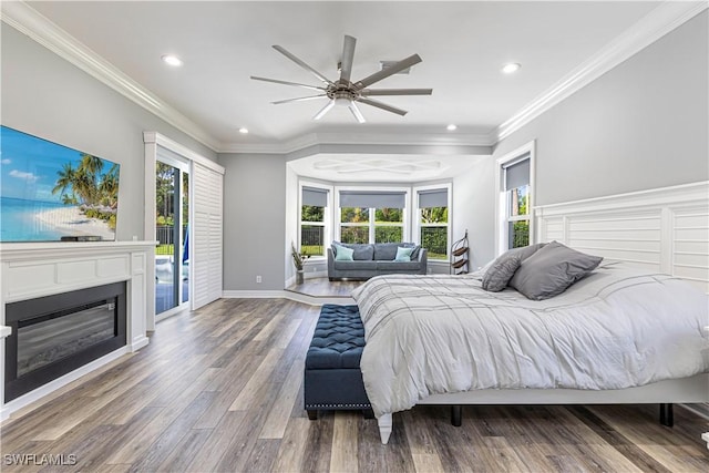 1801 Senegal Date Dr, Naples, FL 34119 - bedroom with access to exterior, recessed lighting, wood finished floors, a glass covered fireplace, and baseboards