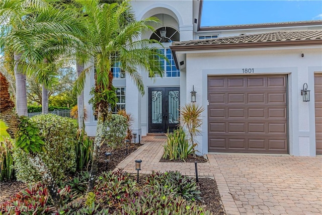 entrance to property featuring french doors and a garage