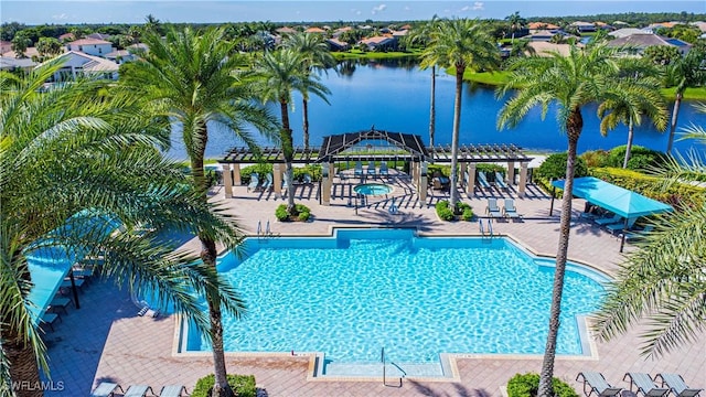 view of swimming pool with a hot tub, a patio, a water view, and a pergola