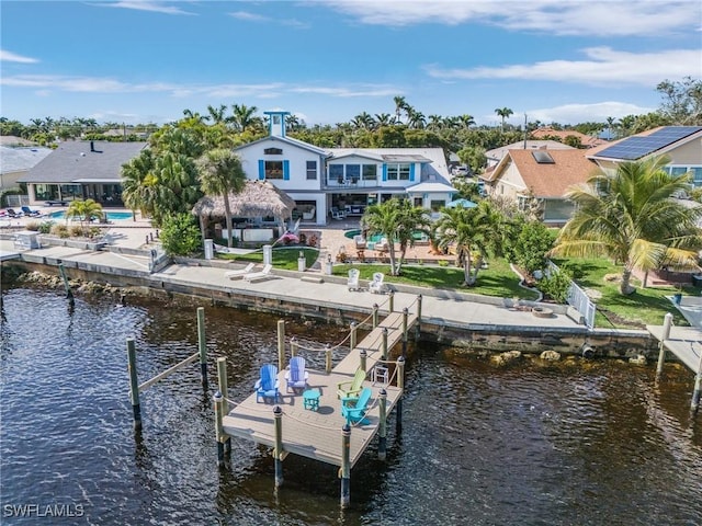 dock area with an outdoor pool, a water view, a patio, and a balcony