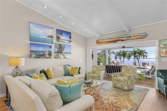 living room with a ceiling fan, lofted ceiling with beams, and hardwood / wood-style flooring