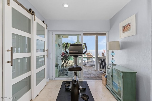 exercise room featuring a barn door