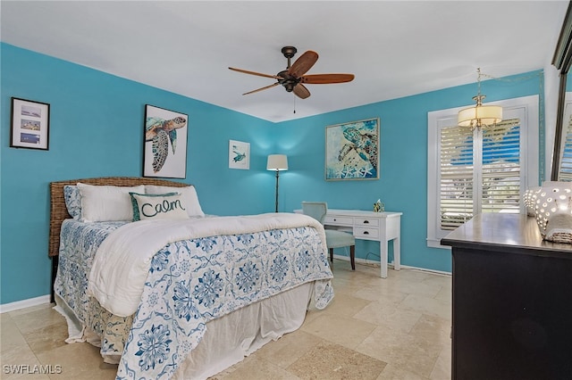 bedroom with ceiling fan and baseboards