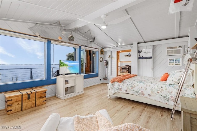 bedroom featuring a wall mounted air conditioner, wood walls, lofted ceiling with beams, and wood finished floors