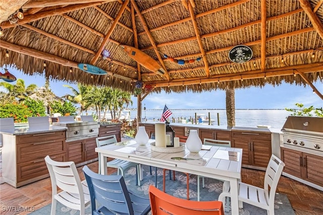 view of patio featuring outdoor dining space, a grill, an outdoor kitchen, and a gazebo