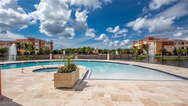 view of swimming pool featuring a community hot tub and a patio