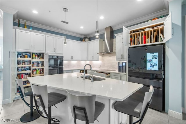 kitchen with sink, ornamental molding, black appliances, white cabinets, and wall chimney exhaust hood