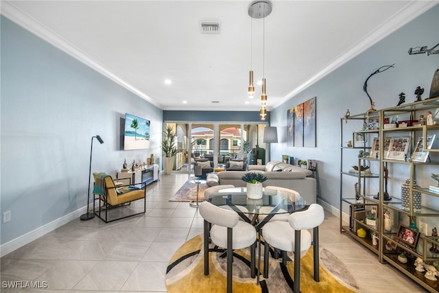 dining area with light tile patterned floors and crown molding