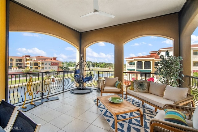 view of patio / terrace with a balcony, a water view, an outdoor hangout area, and ceiling fan