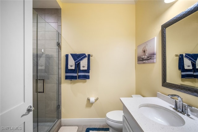 bathroom featuring vanity, ornamental molding, a shower with door, and toilet