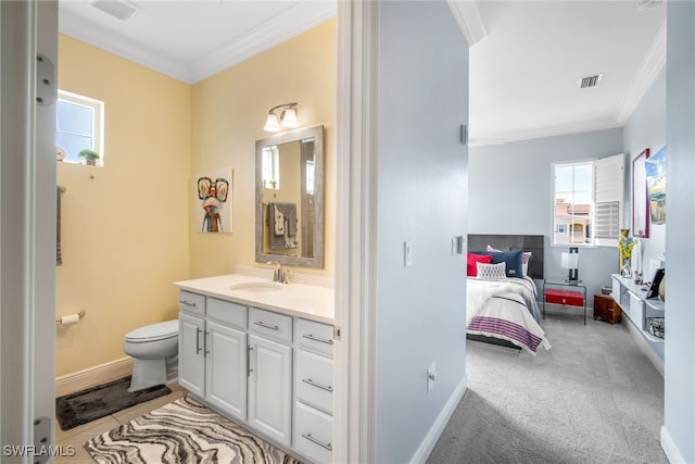 bathroom with ornamental molding, toilet, and vanity