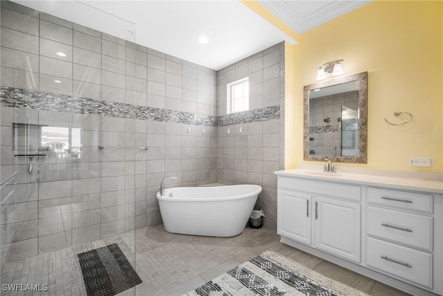 bathroom featuring independent shower and bath, tile walls, vanity, ornamental molding, and tile patterned floors