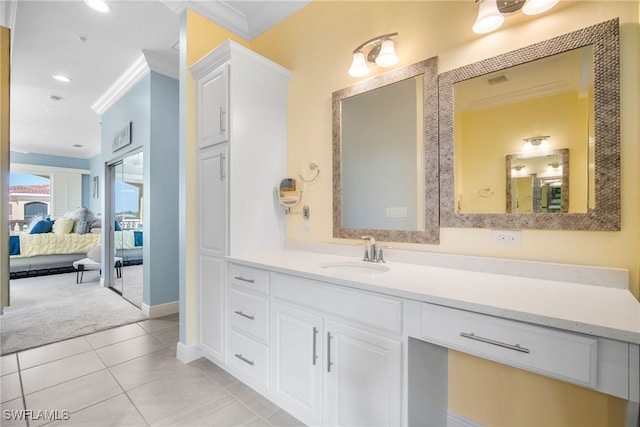 bathroom with crown molding, tile patterned floors, and vanity