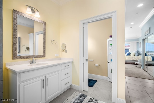 bathroom with tile patterned flooring, vanity, and crown molding