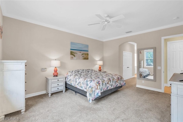 bedroom with crown molding, light colored carpet, and ceiling fan