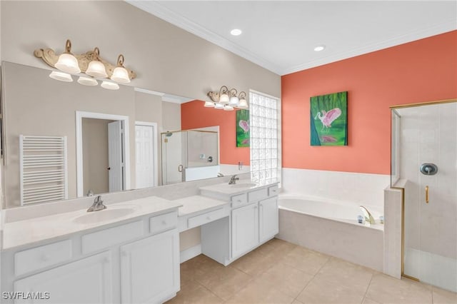 bathroom with radiator heating unit, vanity, ornamental molding, tile patterned floors, and independent shower and bath